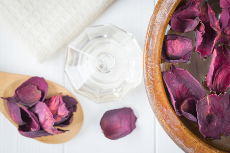 Spa background with beautiful rose petals and a clay bowl. Set for the treatment of skin and nails. Alternative medicine.の写真素材