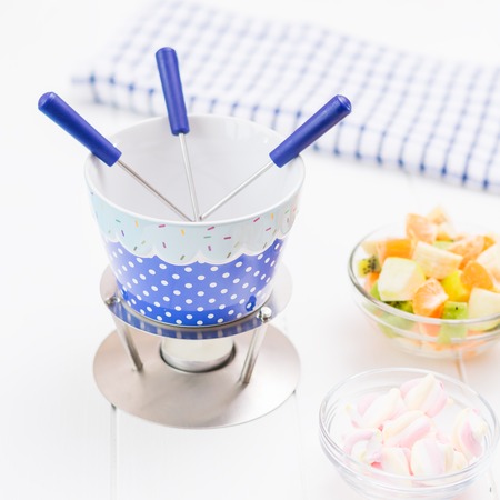 Fondue chocolate, marshmallows, apple, tangerine, kiwi and banana. Homemade holiday dish. Children's party.の写真素材