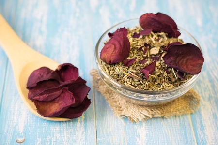 Herbal tea with rose petals on a rustic table. Drink Alternative Medicine.の写真素材