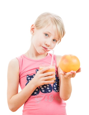 Sport girl with a grapefruit in the hands of a smoothie drink. Isolated on white background. The concept of healthy nutrition for children.の写真素材