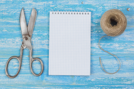 Scissors, notebook, and a rough rope on a wooden table. The concept of training surprise.の写真素材