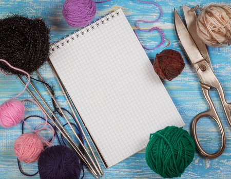 Background notebook and accessories for knitting wool. The concept of home handicraft.の写真素材