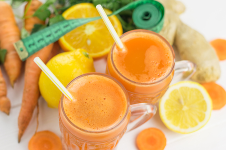 Carrot smoothie with grapefruit and parsley on a wooden table. The concept diet food for weight loss. Top view.の写真素材