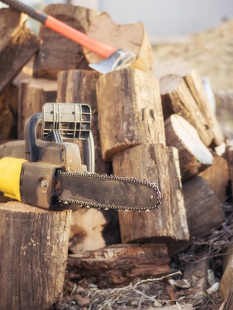 Electric saw chain on the background of sawn timber. The concept of processing wood to produce fuel.の写真素材