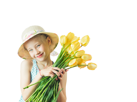 Beautiful girl with a bouquet of yellow tulips. Portrait of a girl with flowers isolated on white background.の写真素材