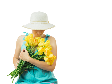 Beautiful woman with a bouquet of flowers isolated on white background. Portrait of a beautiful woman.の写真素材
