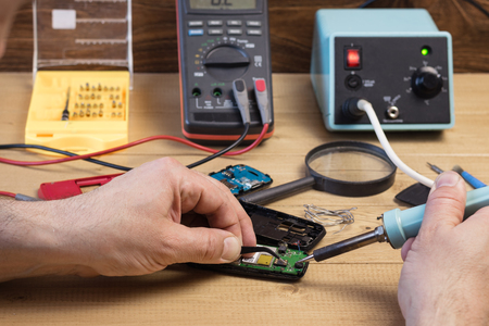 Supplies for the repair of a modern mobile phone. Picture from a workshop for repairing electronic devices.の写真素材