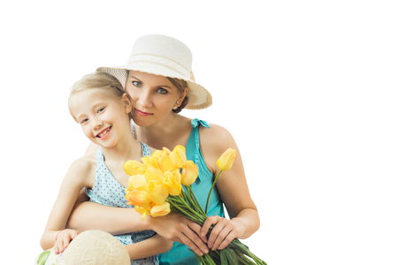 Little girl tenderly embraces his mother isolated on white background. The concept of family happiness.の写真素材