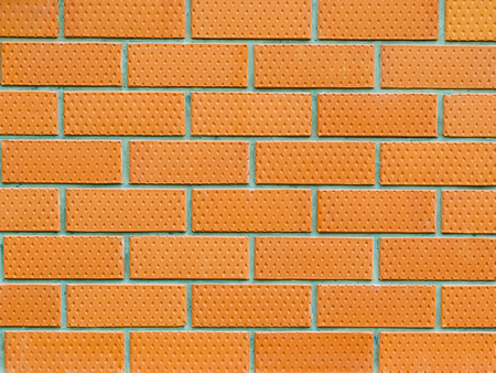 Background of red brick wall with grey mortar. Wall of brick with patterns of diamonds.の写真素材