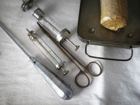 Set of vintage medical instruments on a white cloth. The concept of the past medicine.の写真素材
