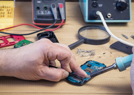 Supplies for the repair of a modern mobile phone. Picture from a workshop for repairing electronic devices.の写真素材