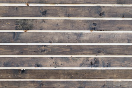 Brown background of wooden boards unevenly colored paint. Vintage brown rustic background.