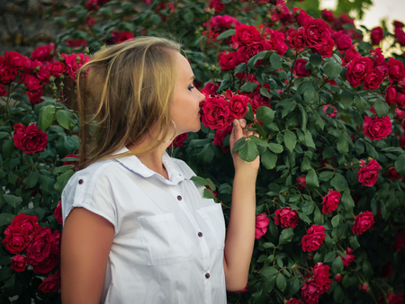 Portrait of beautiful woman in flowers, bright red hips. Beautiful portrait of the beautiful plants.の写真素材