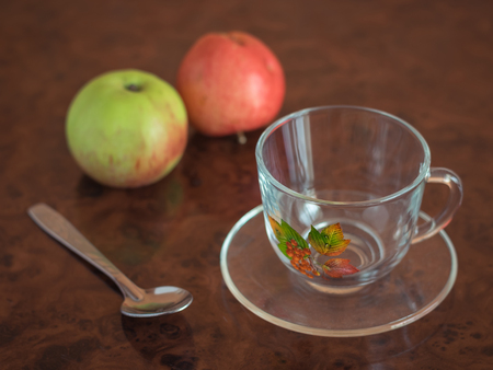 Empty coffee Cup with spoon and two apples on the table. The concept of a healthy Breakfast.の写真素材