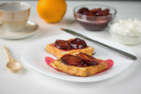 Toasted French bread with curd cream and plum jam. The concept of organic Breakfast. Diet.の写真素材