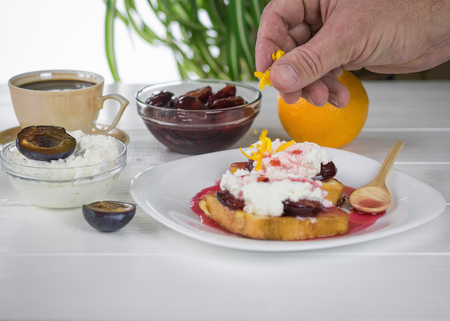Toasted French bread with curd cream and plum jam. The concept of organic Breakfast. Diet.の写真素材