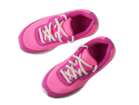 Womens pink sneakers with white laces isolated on white background. Beautiful and comfortable shoes for fitness training. View from above.の写真素材