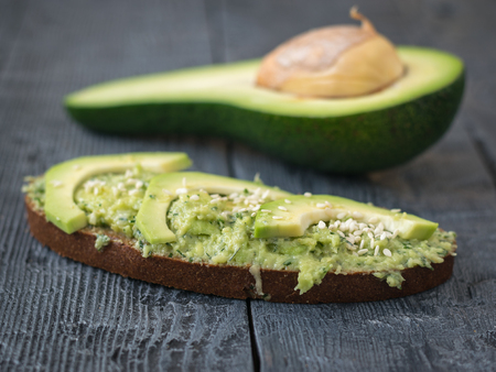 Two slices of bread from wheat flour smeared with cream of avocado with herbs. A vegetarian diet. A healthy way of life.の写真素材