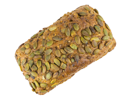 A loaf of bread from wheat flour with sunflower, pumpkin, caraway, cereal and sesame seeds. Isolated. Top view.の写真素材