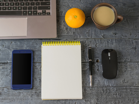 Notebook, notebook, pen, coffee Cup and marshmallow on the dark wooden table. The view from the top.の写真素材