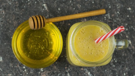 Freshly made smoothies with mango, banana, orange and cereal. Food healthy lifestyle. Raw natural food. The view from the top.の写真素材
