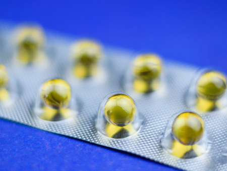 Fish oil pills in a blister selective focus. Background of medicines.の写真素材