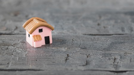 Ceramic model of a house on wooden table. The view from the top. Selective focus.の写真素材