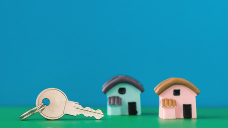 Ceramic model of a house and key on color table. Selective focus.の写真素材