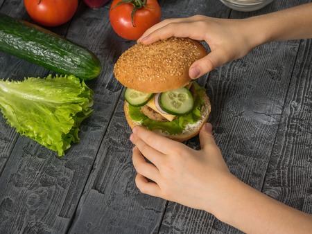The girl ends up cooking a hamburger for lunch. Cooking hamburger for school lunch child.の写真素材