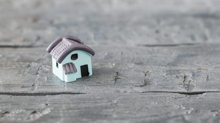 Model little blue house on a wooden table. The view from the top. Selective focus.の写真素材