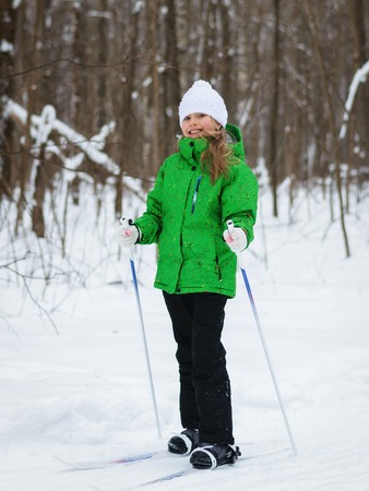 She is in a good mood on the slopes in the winter forest.の写真素材