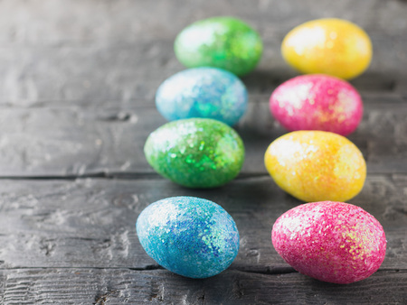 Multicolored Easter eggs on a rustic table. The decoration of the Easter table.の写真素材