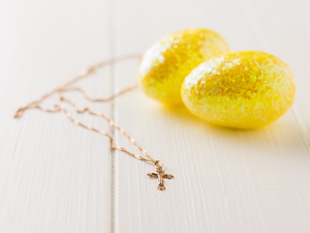 Two golden eggs on a dark wooden table. The decoration of the Easter table. Great Christian holiday.の写真素材