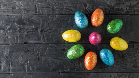 Flower of Easter eggs on a dark wooden table. The decoration of the Easter table. Great Christian holiday. The view from the top.の写真素材