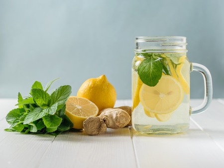 A freshly prepared drink made of lemon and mint on a wooden floor.の写真素材