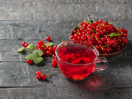 Therapeutic drink of red currant berries and fresh berries on the village table. Refreshing natural drink. The concept of healthy natural food.の写真素材