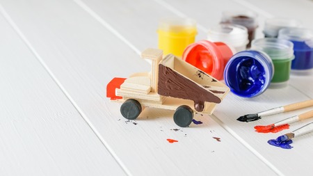 Multi-colored brushes and jars of paint on a white wooden table. Creative kit. Hobby and style.の写真素材
