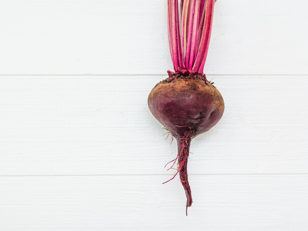 Fresh red beetroot on a white wooden table. Health food. Vegetarian food. The view from the top. Flat lay.の写真素材