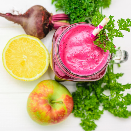 Fresh beetroot smoothie, lemon and parsley on white wooden table. The concept of dietary natural food. Nutrition for weight loss. The view from the top. Flat lay.の写真素材