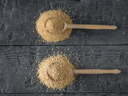 Wooden spoon with quinoa seeds and wooden spoon with amaranth seeds. Gluten free food. The view from the top. Flat lay.の写真素材