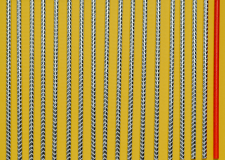 Background of one red tube on the right and bright striped on yellow background. Minimalist style.の写真素材