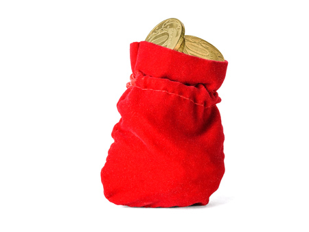 Red cloth pouch filled with coins isolated on white background. The concept of saving cash savings.の写真素材