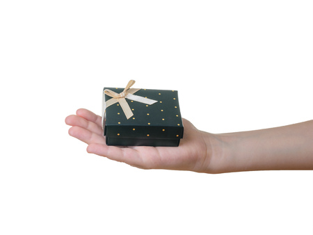 The hand of the child with a gift isolated on a white background. An unknown surprise in a beautiful...