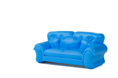Toy modern blue beautiful sofa isolated on white background. A sample of beautiful furniture for the house. Minimalist.の写真素材