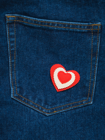 Pocket blue jeans with a red and white heart. Romantic style in fashionable clothes.の写真素材