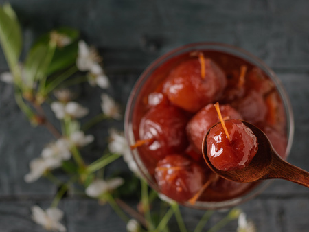 Spoon with Apple jam on the background of a vase with jam from whole apples. Homemade sweets according to old recipes. Flat lay.の写真素材