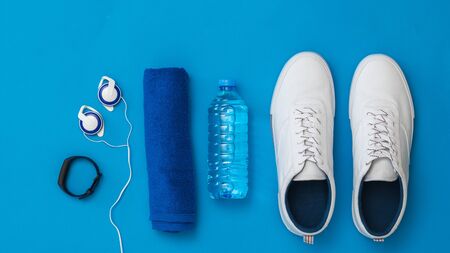 Fitness accessories blue background. Sports style. Flat lay. The view from the top.の写真素材