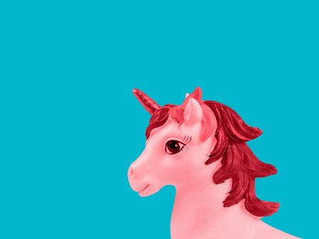 Toned image of a unicorn on a turquoise background. Trend. Minimalism. Lifestyle. Contemporary art collage.の写真素材
