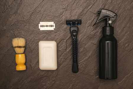 Men's razor, shaving brush, soap and blade on a stone background. Set for care of a man's face. Flat lay.の写真素材
