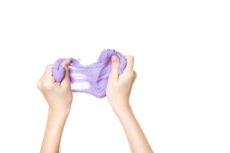 Stretched lilac slime in hands isolated on a white background. Toy antistress. Toy for the development of hand motor skills.の写真素材